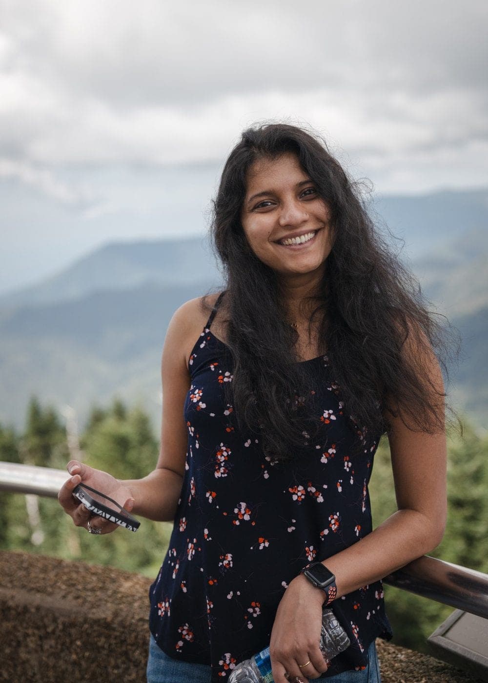Sonali smiling at a mountain overlook
